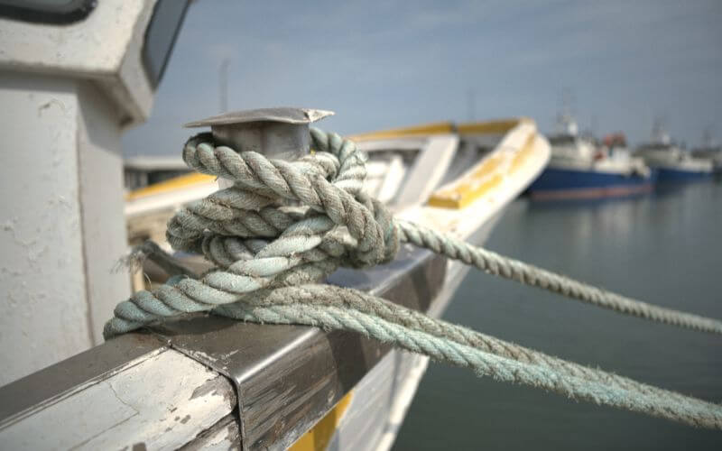 A boat tied to a Dock